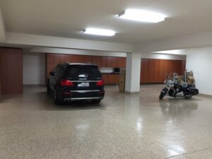 Garage with wood cabinets, SUV and motorcycle